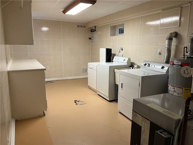 7 Orchard Pl, Bradford-City, PA 16701 - laundry room with washer and clothes dryer, tile walls, and gas water heater