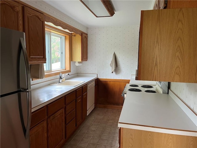 7 Orchard Pl, Bradford-City, PA 16701 - kitchen with white appliances, wallpapered walls, light countertops, a wainscoted wall, and brown cabinets