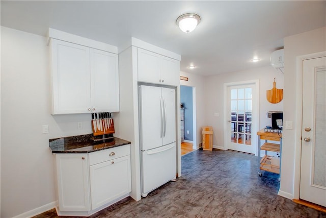 16353 W Lake Rd, Pulteney, NY 14418 - kitchen featuring freestanding refrigerator, white cabinets, an AC wall unit, and dark stone countertops
