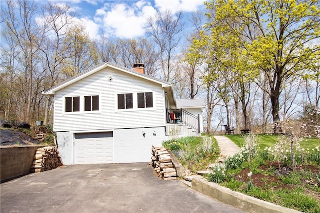 16353 W Lake Rd, Pulteney, NY 14418 - view of front of home with a chimney, stairs, asphalt driveway, and an attached garage