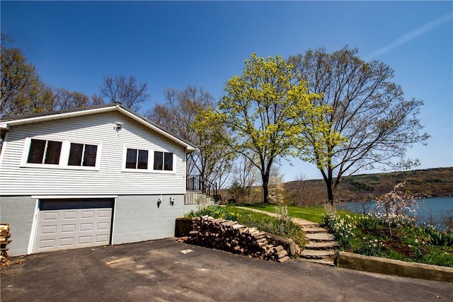 16353 W Lake Rd, Pulteney, NY 14418 - view of property exterior featuring a garage, driveway, and stairs