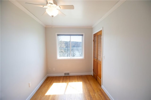 16353 W Lake Rd, Pulteney, NY 14418 - unfurnished bedroom featuring light wood-style flooring, a closet, ornamental molding, and a ceiling fan