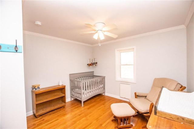 16353 W Lake Rd, Pulteney, NY 14418 - bedroom with light wood-type flooring, ornamental molding, a nursery area, and a ceiling fan