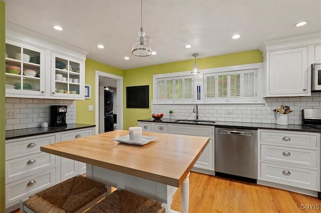 3864 Bristol Rd, Kirkland, NY 13323 - kitchen with appliances with stainless steel finishes, decorative backsplash, white cabinets, wooden counters, and recessed lighting