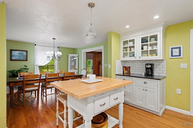 3864 Bristol Rd, Kirkland, NY 13323 - kitchen with wooden counters, white cabinets, light wood-type flooring, tasteful backsplash, and recessed lighting
