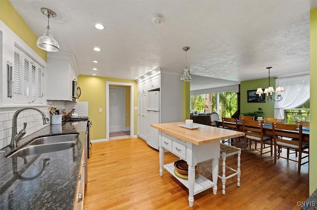 3864 Bristol Rd, Kirkland, NY 13323 - kitchen featuring appliances with stainless steel finishes, butcher block countertops, white cabinetry, backsplash, and light wood-style floors