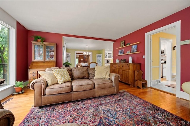 3864 Bristol Rd, Kirkland, NY 13323 - living area featuring wood finished floors and a chandelier