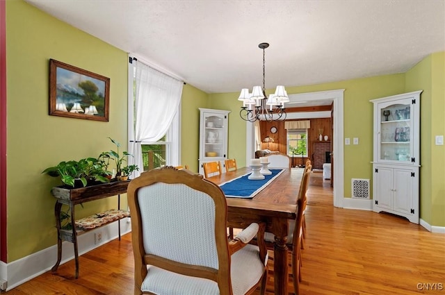 3864 Bristol Rd, Kirkland, NY 13323 - dining space featuring a chandelier and light wood-style floors