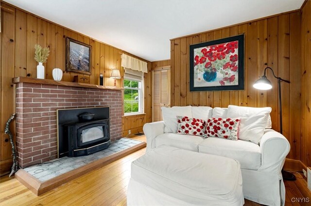 3864 Bristol Rd, Kirkland, NY 13323 - living area with wood walls, hardwood / wood-style floors, and a wood stove