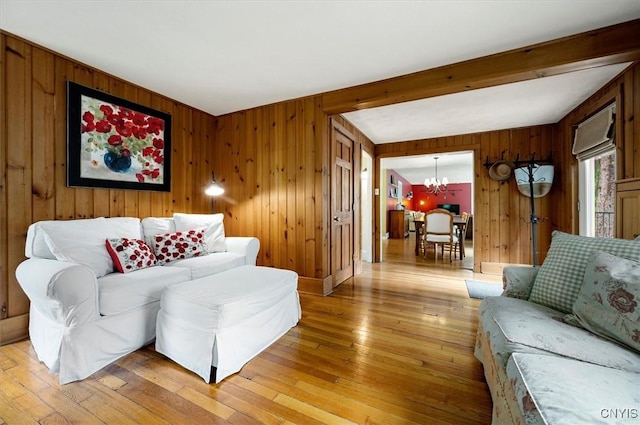 3864 Bristol Rd, Kirkland, NY 13323 - living area with a chandelier, wooden walls, light wood-style floors, and beamed ceiling