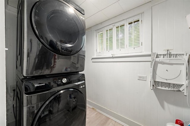 3864 Bristol Rd, Kirkland, NY 13323 - washroom featuring stacked washing machine and dryer and light wood-type flooring
