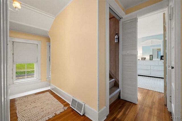 3864 Bristol Rd, Kirkland, NY 13323 - hallway featuring wood finished floors, ornamental molding, and stairway