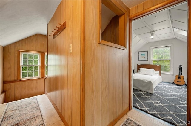 3864 Bristol Rd, Kirkland, NY 13323 - corridor with lofted ceiling, plenty of natural light, wooden walls, and track lighting