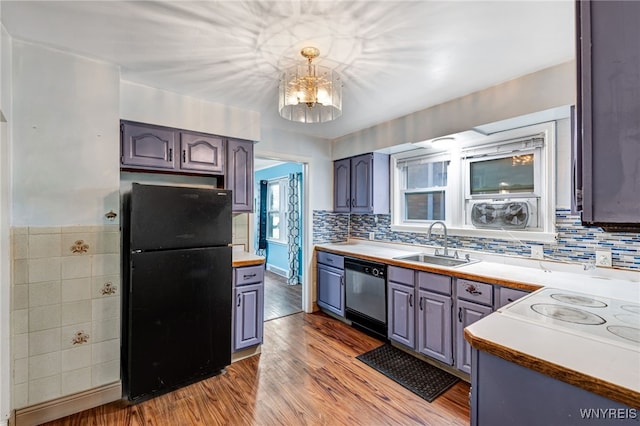 2776 Forest Ave, Niagara Falls, NY 14303 - kitchen featuring freestanding refrigerator, stainless steel dishwasher, a chandelier, light wood finished floors, and light countertops
