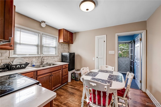 2776 Forest Ave, Niagara Falls, NY 14303 - kitchen with brown cabinets, backsplash, light countertops, and dark wood-type flooring