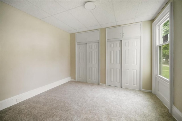 37 Nelson St, Auburn, NY 13021 - unfurnished bedroom with two closets, carpet flooring, and a drop ceiling