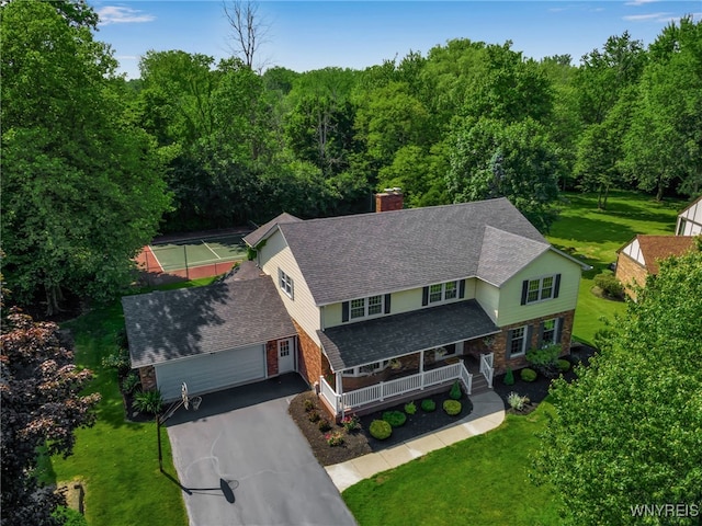 44 Deer Run, Amherst, NY 14221 - view of front facade with a chimney, driveway, covered porch, and a front yard