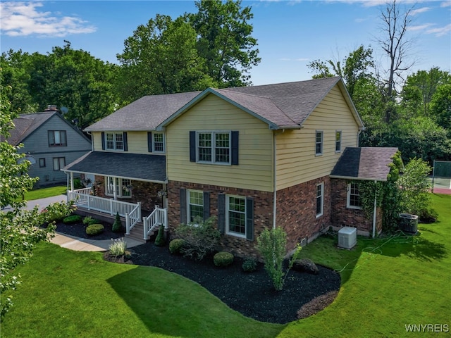 44 Deer Run, Amherst, NY 14221 - traditional-style house featuring covered porch, a front lawn, and a shingled roof