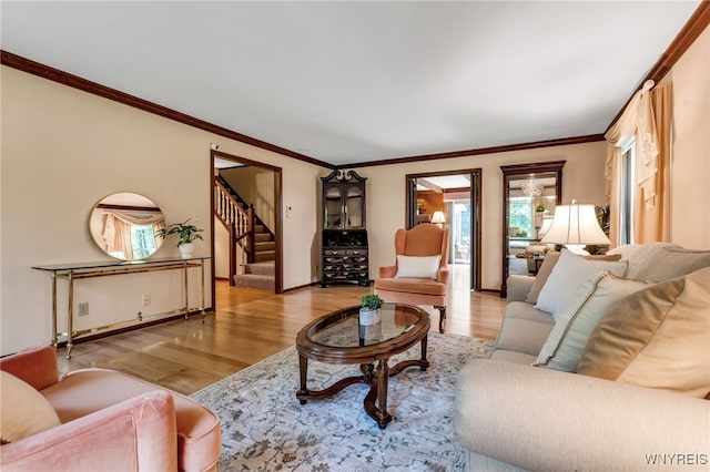 44 Deer Run, Amherst, NY 14221 - living room featuring wood finished floors, healthy amount of natural light, stairway, and crown molding