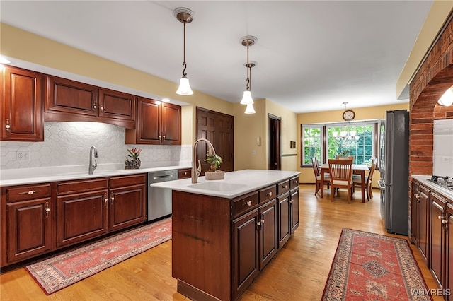 44 Deer Run, Amherst, NY 14221 - kitchen featuring appliances with stainless steel finishes, light countertops, decorative backsplash, and light wood-type flooring