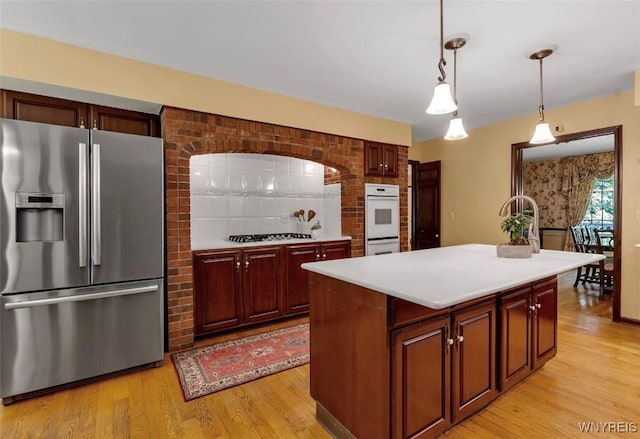 44 Deer Run, Amherst, NY 14221 - kitchen featuring stainless steel refrigerator with ice dispenser, white double oven, backsplash, light wood-style floors, and light countertops