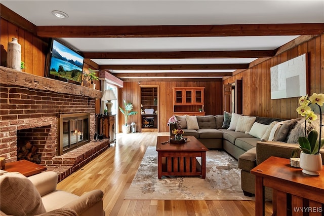 44 Deer Run, Amherst, NY 14221 - living area with wooden walls, a fireplace, beamed ceiling, and hardwood / wood-style flooring