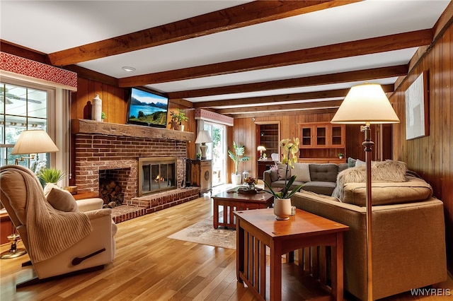 44 Deer Run, Amherst, NY 14221 - living room with wood walls, wood finished floors, beam ceiling, a fireplace, and plenty of natural light