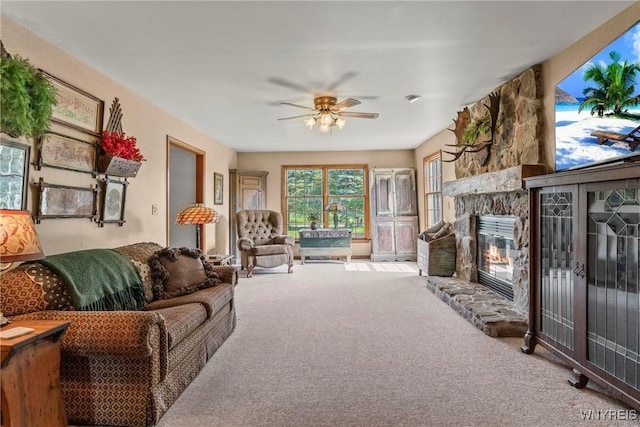 8345 Lapp Rd, Clarence, NY 14051 - living room with carpet floors, a stone fireplace, and a ceiling fan