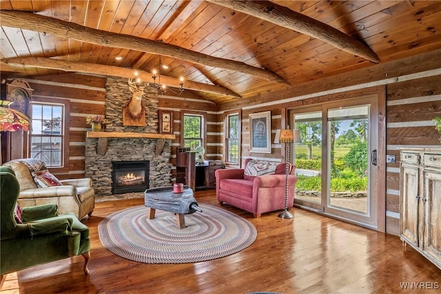 8345 Lapp Rd, Clarence, NY 14051 - living area with wood finished floors, healthy amount of natural light, wood ceiling, a stone fireplace, and wooden walls