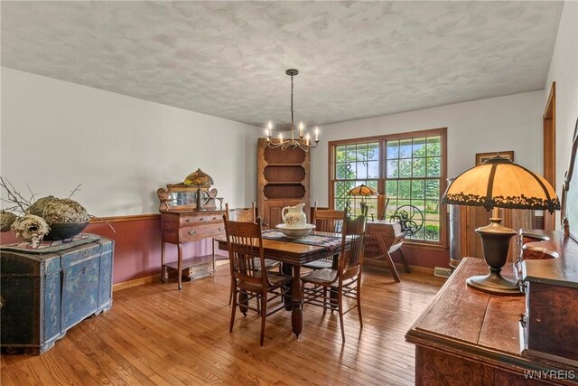 8345 Lapp Rd, Clarence, NY 14051 - dining space featuring hardwood / wood-style floors, a chandelier, and a textured ceiling