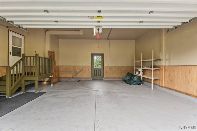 8345 Lapp Rd, Clarence, NY 14051 - garage featuring a wainscoted wall and wooden walls