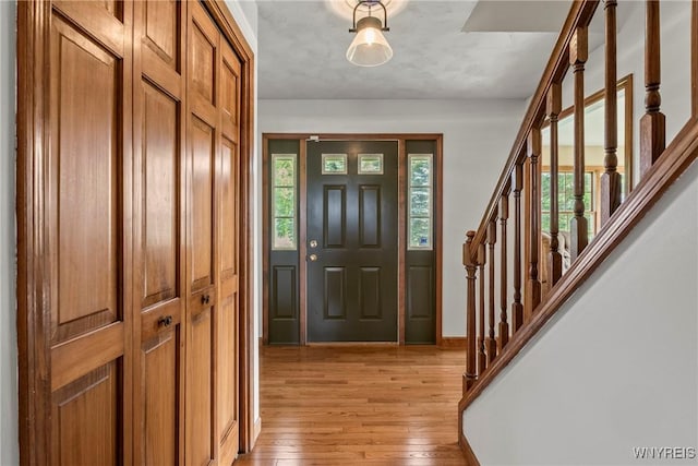8345 Lapp Rd, Clarence, NY 14051 - entryway with light wood finished floors and stairs