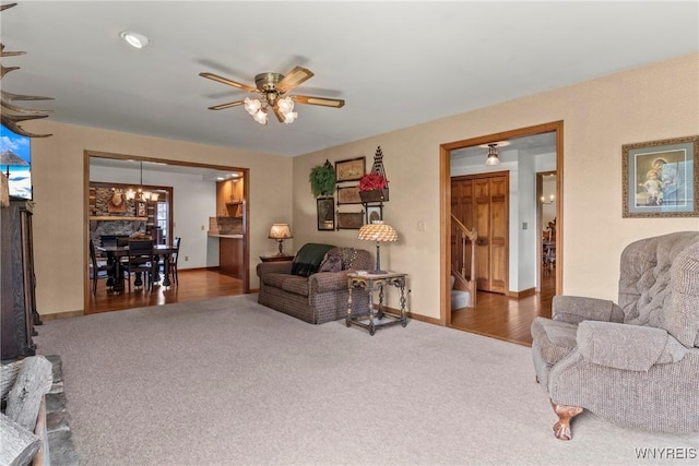8345 Lapp Rd, Clarence, NY 14051 - carpeted living area with a chandelier, ceiling fan, and stairs