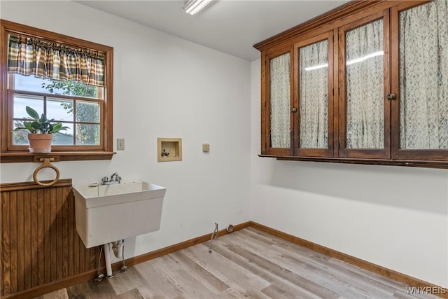 8345 Lapp Rd, Clarence, NY 14051 - laundry area with light wood-style flooring, hookup for a washing machine, and cabinet space