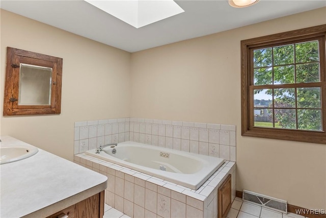 8345 Lapp Rd, Clarence, NY 14051 - bathroom featuring tile patterned flooring, a garden tub, vanity, and a skylight