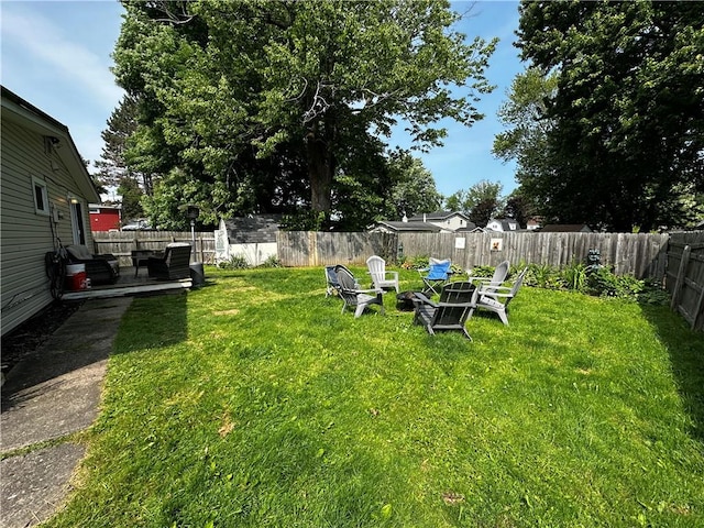22 Orchard Rd, Greece, NY 14612 - fenced backyard featuring an outdoor fire pit