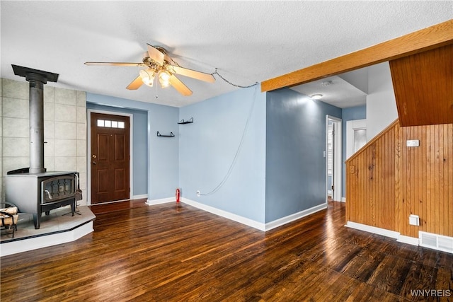 55 Spruce Rd, Amherst, NY 14226 - unfurnished living room with a ceiling fan, a wood stove, wood finished floors, and a textured ceiling