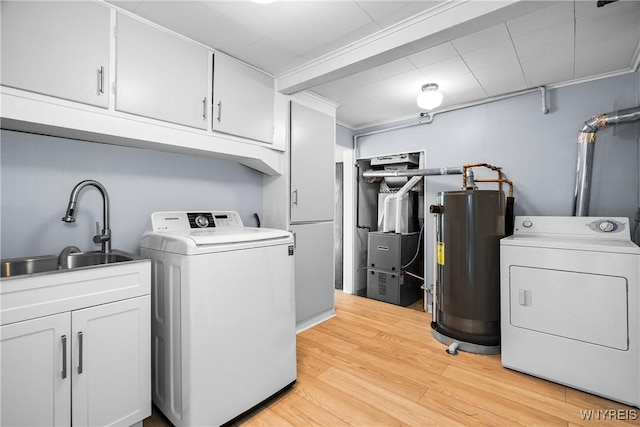 55 Spruce Rd, Amherst, NY 14226 - washroom featuring water heater, washer and dryer, cabinet space, light wood-style flooring, and heating unit