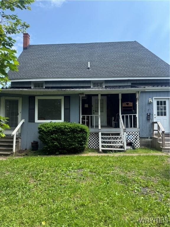 38 N Main St, Royalton, NY 14105 - back of house featuring roof with shingles, a lawn, and a chimney