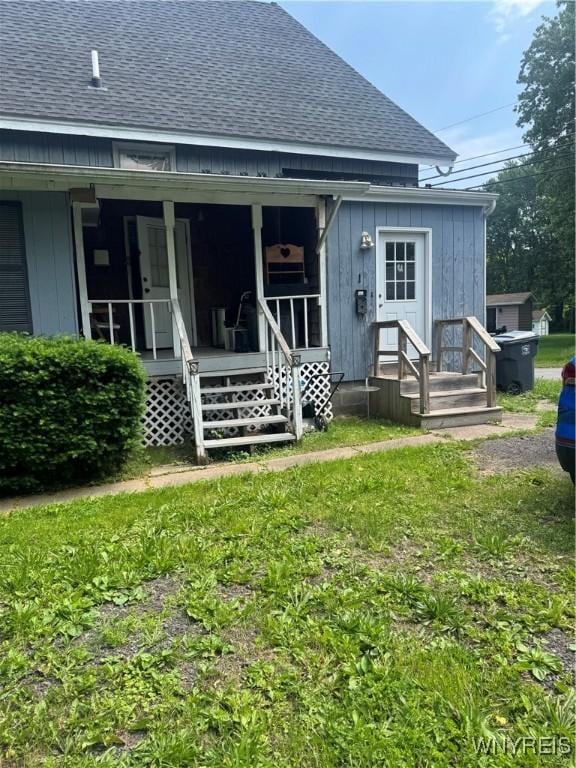 38 N Main St, Royalton, NY 14105 - back of property featuring a shingled roof, board and batten siding, and a yard