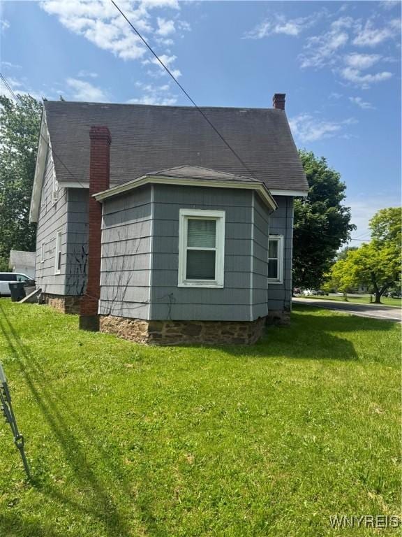 38 N Main St, Royalton, NY 14105 - view of property exterior with a yard and a chimney