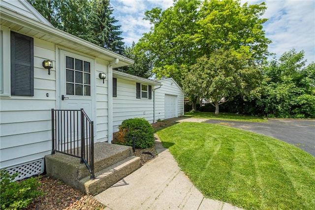 19 Rahway Rd, Gates, NY 14606 - doorway to property featuring driveway, a lawn, and a detached garage