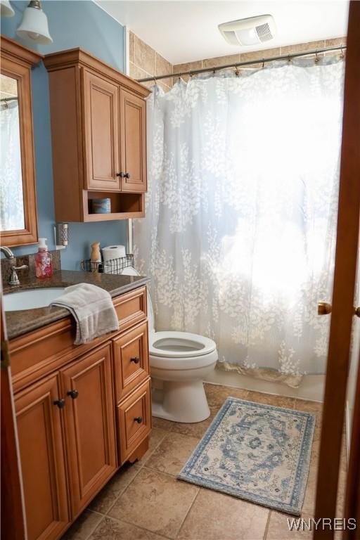 1422 Master St, North Tonawanda, NY 14120 - full bathroom featuring vanity, tile patterned flooring, and curtained shower