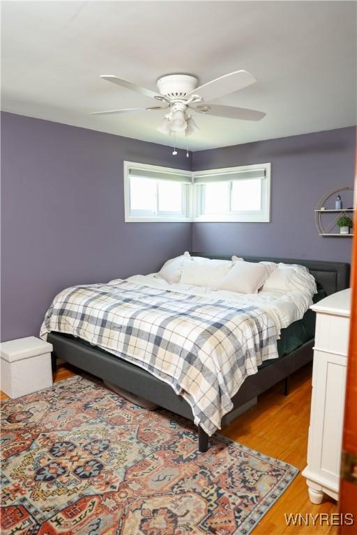 1422 Master St, North Tonawanda, NY 14120 - bedroom with multiple windows, light wood finished floors, and ceiling fan