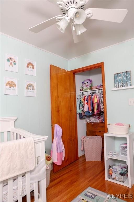 1422 Master St, North Tonawanda, NY 14120 - bedroom with wood finished floors, crown molding, ceiling fan, and a closet