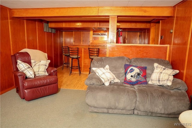 1422 Master St, North Tonawanda, NY 14120 - living room featuring wood walls, a bar, wood finished floors, and carpet floors