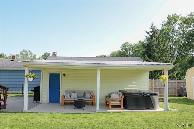 1422 Master St, North Tonawanda, NY 14120 - rear view of property with a patio area, a hot tub, an outdoor living space, and a chimney