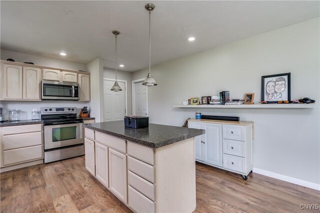 30656 Nys Route 37, Le Ray, NY 13637 - kitchen with stainless steel appliances, light wood finished floors, a center island, dark countertops, and recessed lighting
