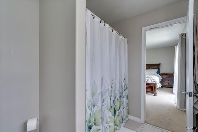 30656 Nys Route 37, Le Ray, NY 13637 - bathroom with a shower with shower curtain, ensuite bath, and tile patterned flooring