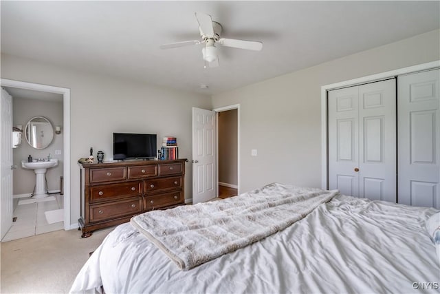 30656 Nys Route 37, Le Ray, NY 13637 - bedroom featuring a closet, light colored carpet, ceiling fan, and ensuite bath